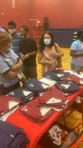 Students look through uniforms for upcoming school year